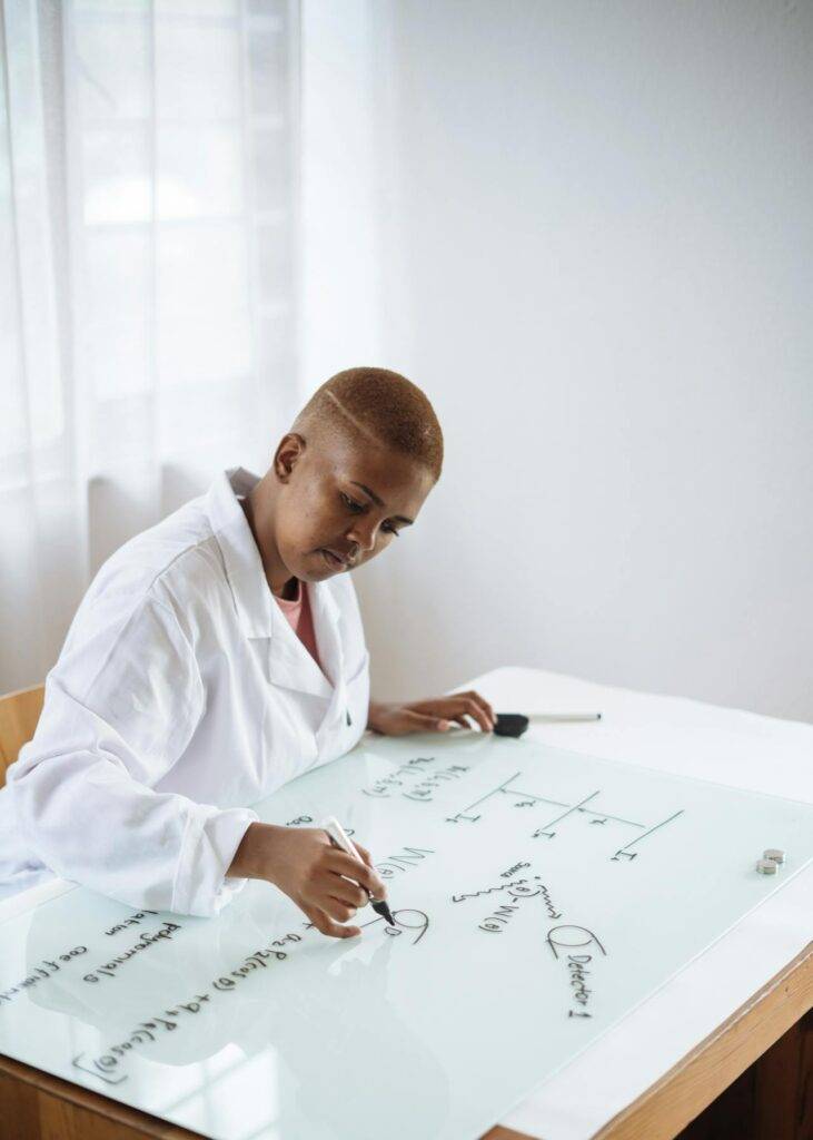 a Scientist Writing on a Whiteboard, Representing the Importance of Scientific Writing in Communicating Information