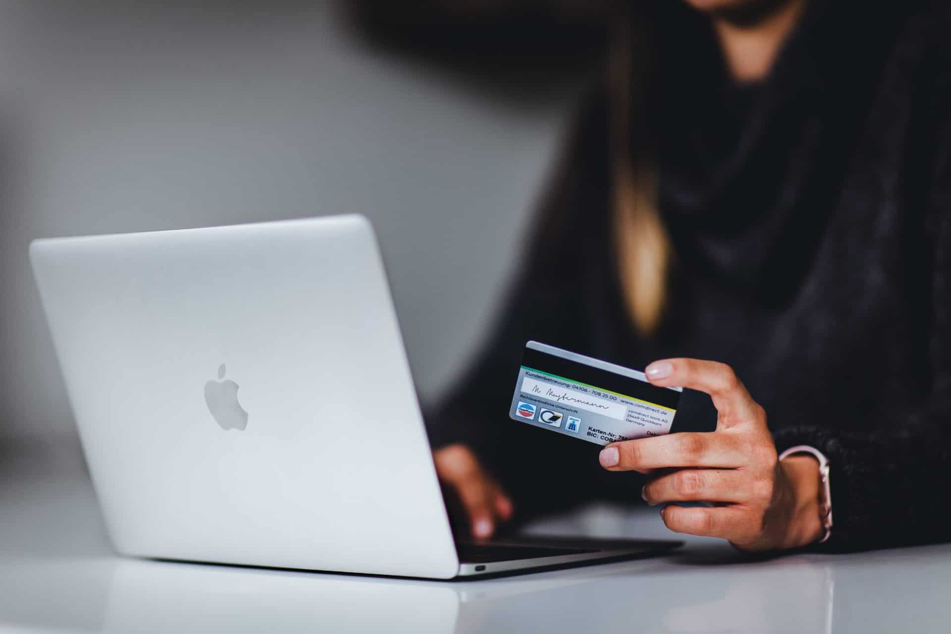 How Enterprise Technical Documentation Saves Time & Money A woman with a laptop and credit card, representing the importance of a security infrastructure design document for eCommerce Sites
