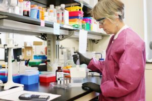 a scientist testing samples in a lab, representing the importance of healthcare SOPs