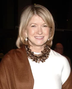 Martha Stewart smiling for the camera, this represents her accomplishment and success.