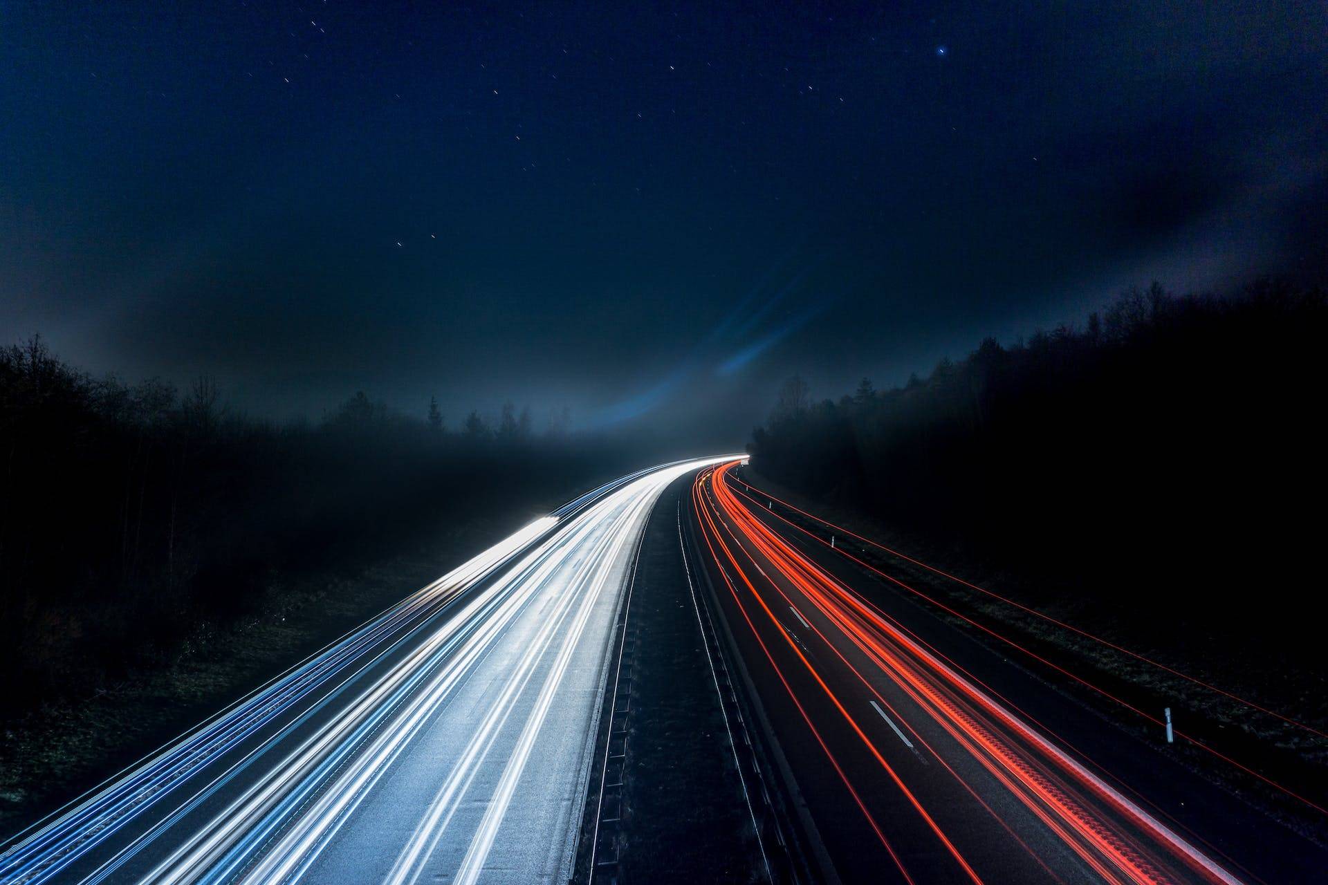 Light Trails of Cars at Night, Representing how Technical Writers work hard to keep the complex modern world we live in moving forward through Standard Operating Procedures