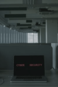 a computer in an empty building, which screen reads "cybersecurity", representing the importance of cybersecurity technical writers