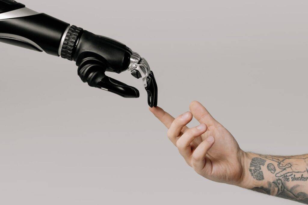 a Robotic Hand and a Human Hand Touching, Representing the Importance of Technical Writing in the AI Age