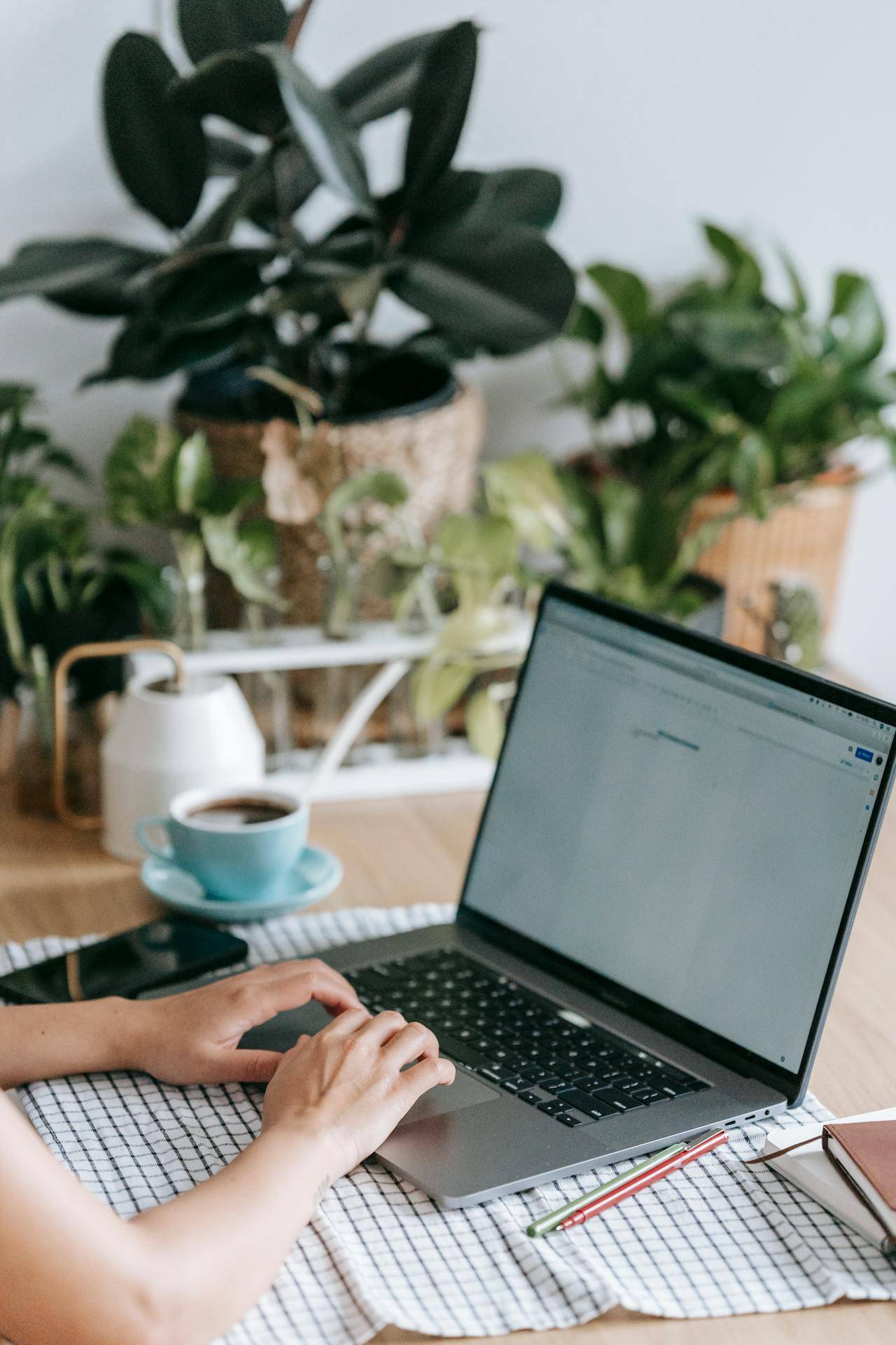 a Tech Writer Sitting at a Desk, Typing on a Laptop, Developing an Owner's Manual