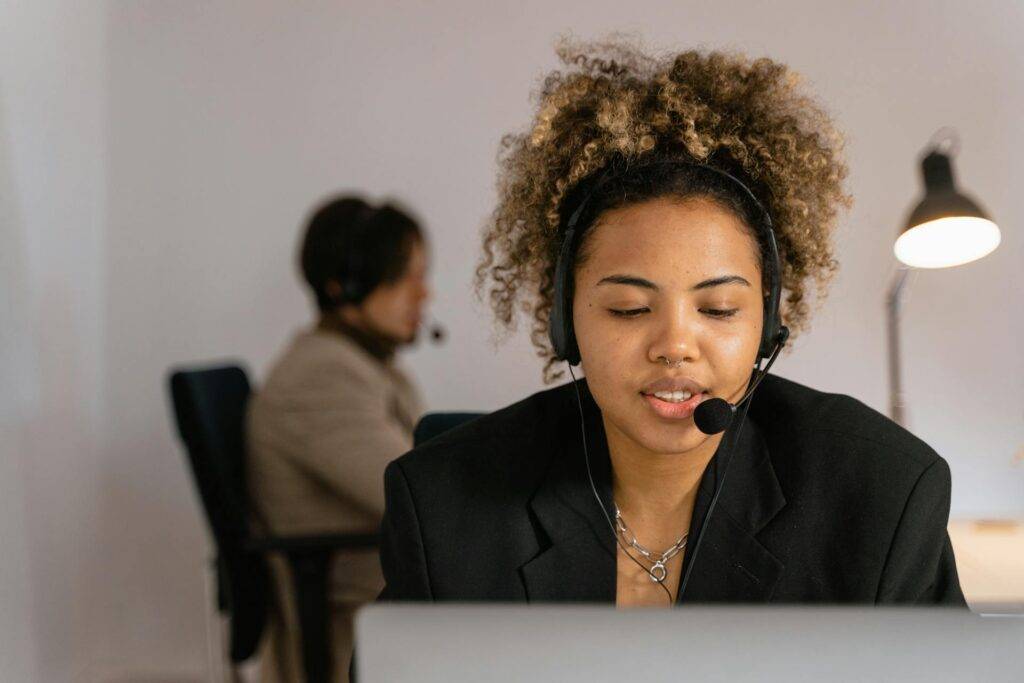 A Woman with a Headset working in Customer Support, Representing the Importance of Employee Training Manuals for Success