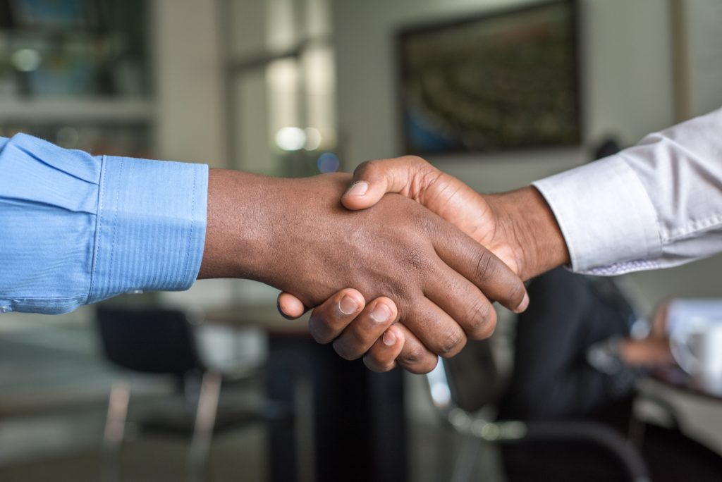 Two business men shaking hands - 5 Powerful Ways Technical Writers Can Streamline Your Business