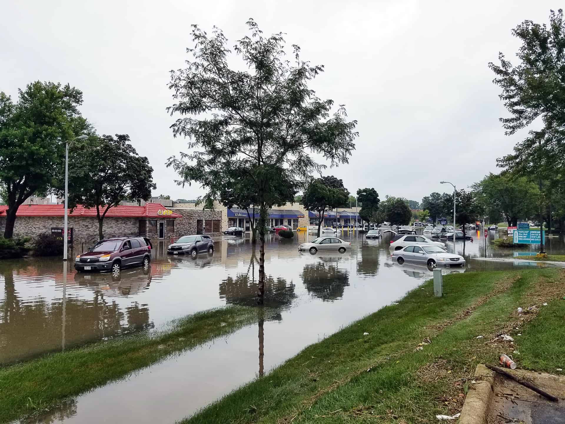a flooded street with cars, representing the importance of a disaster recovery plan