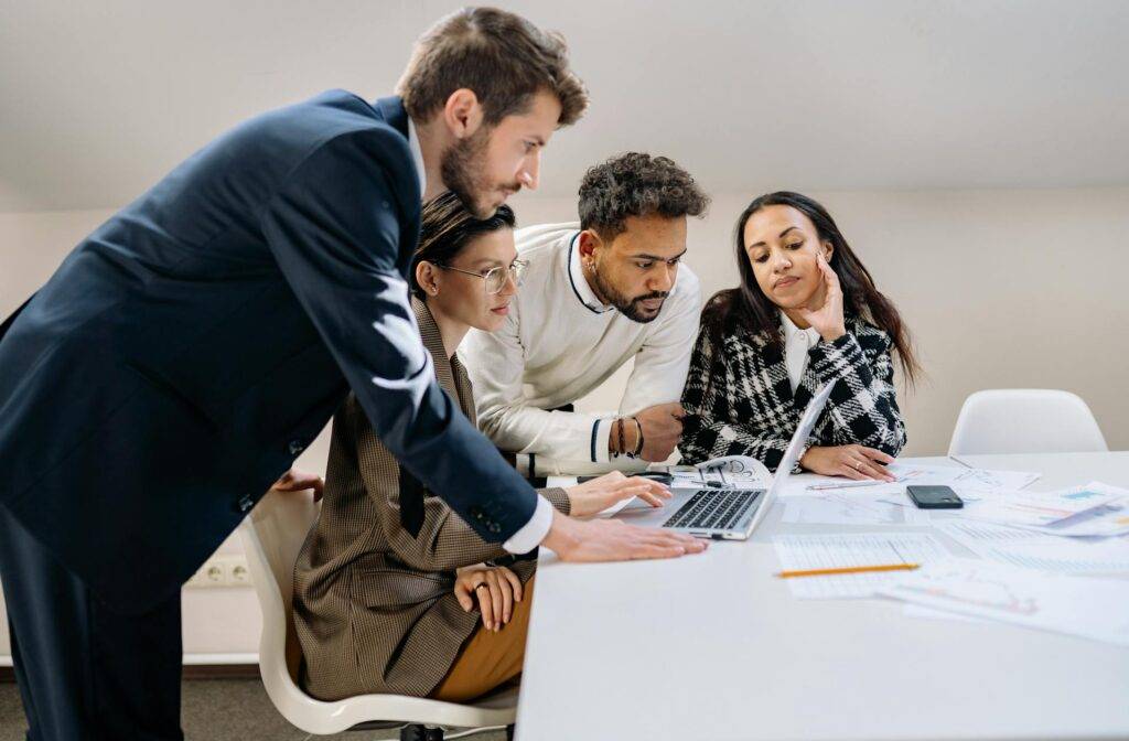 a Group of Employees Reviewing Instruction Manuals for their Company Product