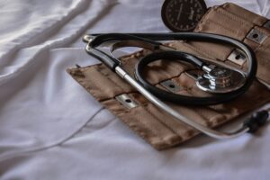 Home care policy and procedures spell out the proper steps to give patients a healthier life, which is represented here by a blood pressure cuff and stethoscope on a bed.