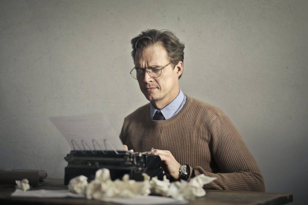 a person writing on a typewriter the benefits of hiring an aerospace technical writer