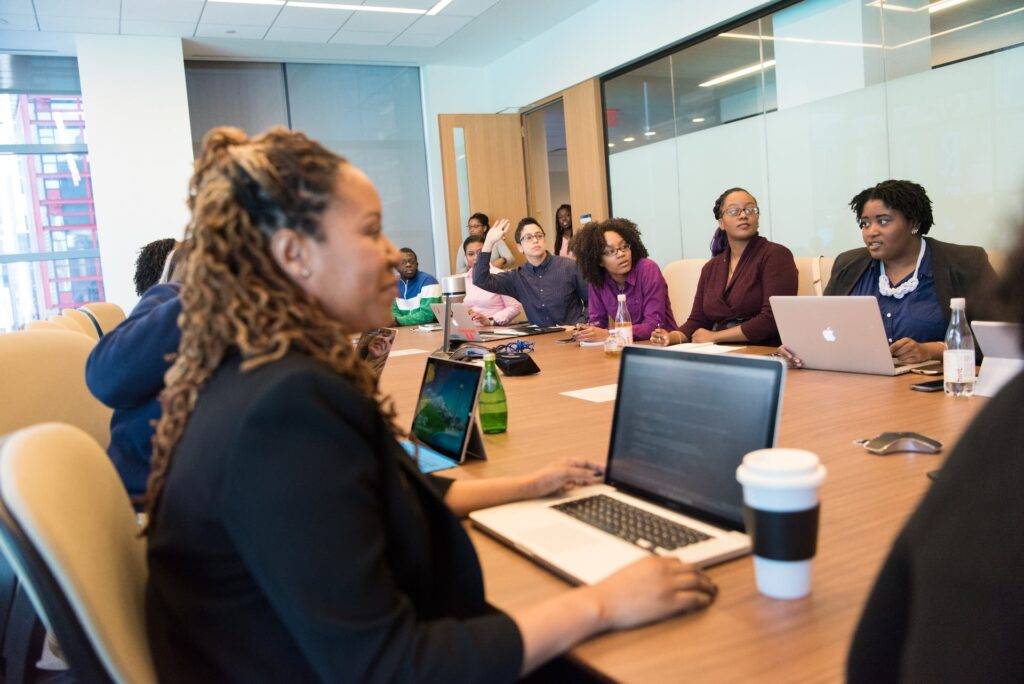 A Group of Employees Sitting Around a Conference Table, Representing the Important Work of SOP Writers in Clarifying a Company's Standard Operating Procedure