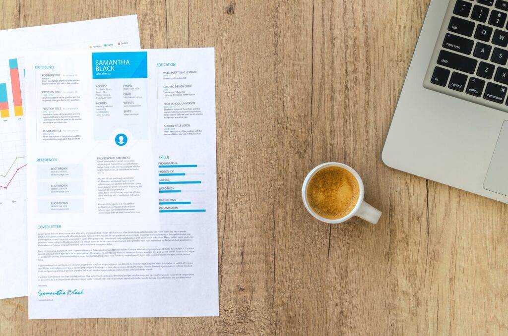 An overhead view of two financial documents on a table next to a laptop and a mug of coffee, highlighting the importance of Audit Documentation.