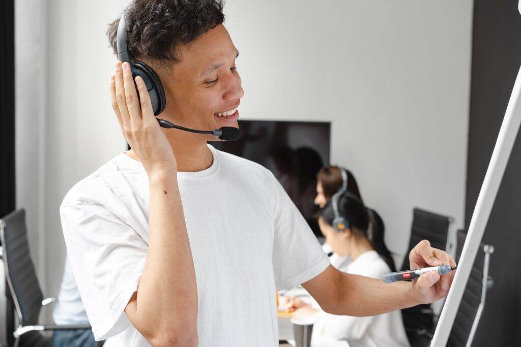 a customer service representative on the phone with a customer, representing the benefits a User Manual has for reducing customer support stress