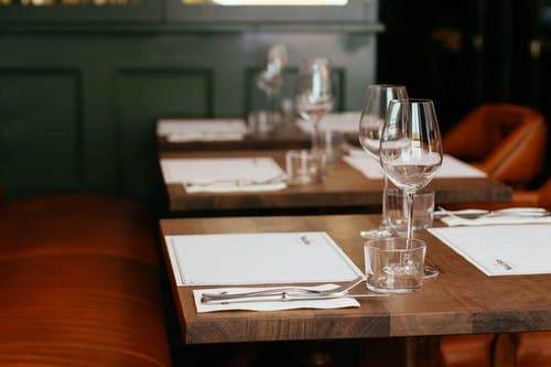 A restaurant table with wine glasses, valuing the importance of restaurant SOPs
