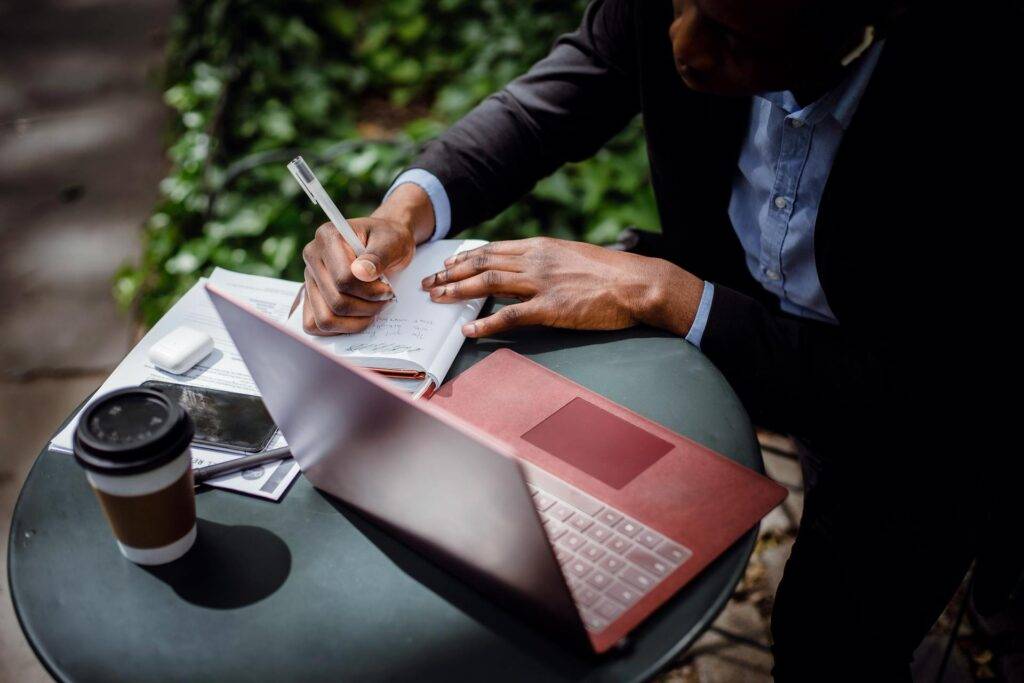 Professional Technical Documentation Writers taking Notes while Looking at a Computer on a Small Table