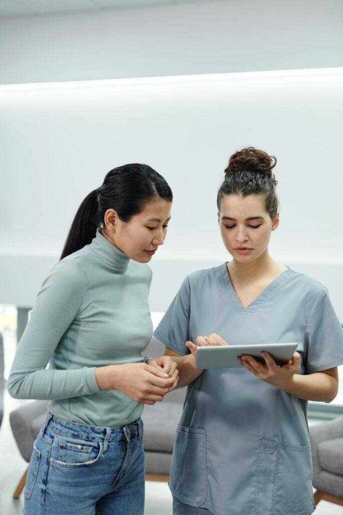 a Patient and a Doctor Look over a Tablet, Representing how Medical Writers Can Produce Helpful Regulatory Medical Documentation