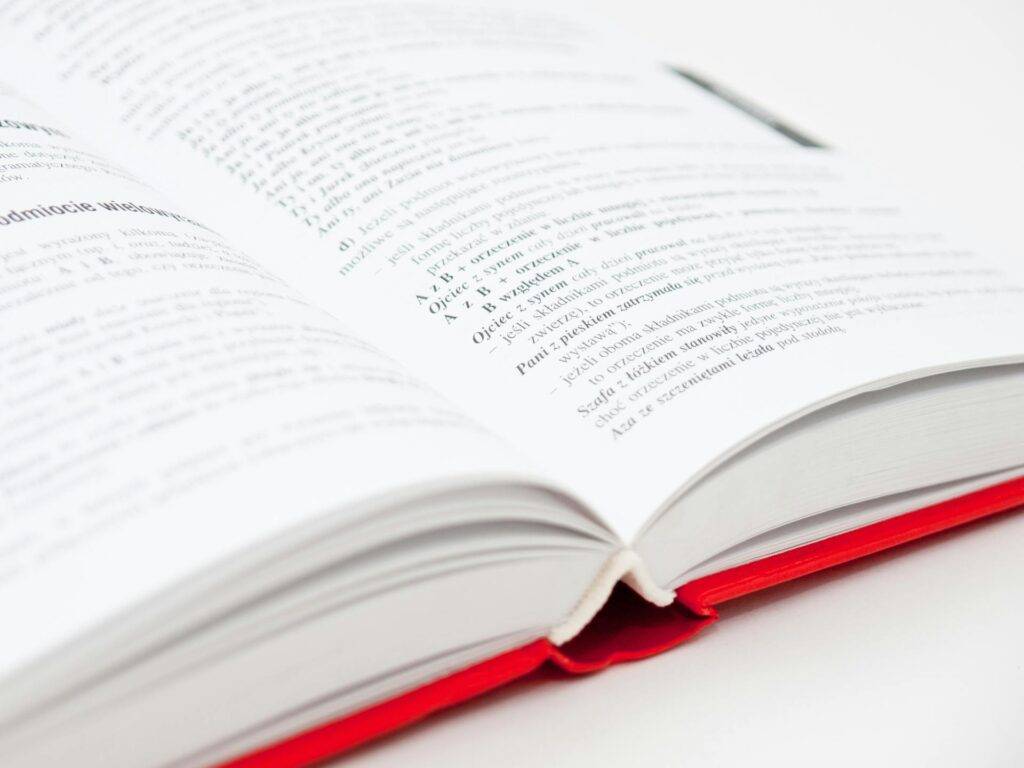 an Open Textbook with a Red Cover, Representing the Key Role of Scientific Writing in Communicating Information to the Public