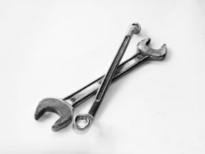 two overlapping wrenches, representing the importance of service manuals in a variety of industries