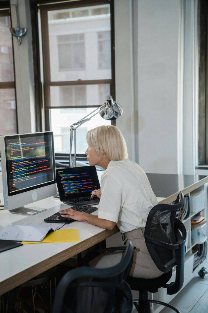 a Software Developer at a Desk Looking at Code, Representing the Importance of Software Documentation for Developers